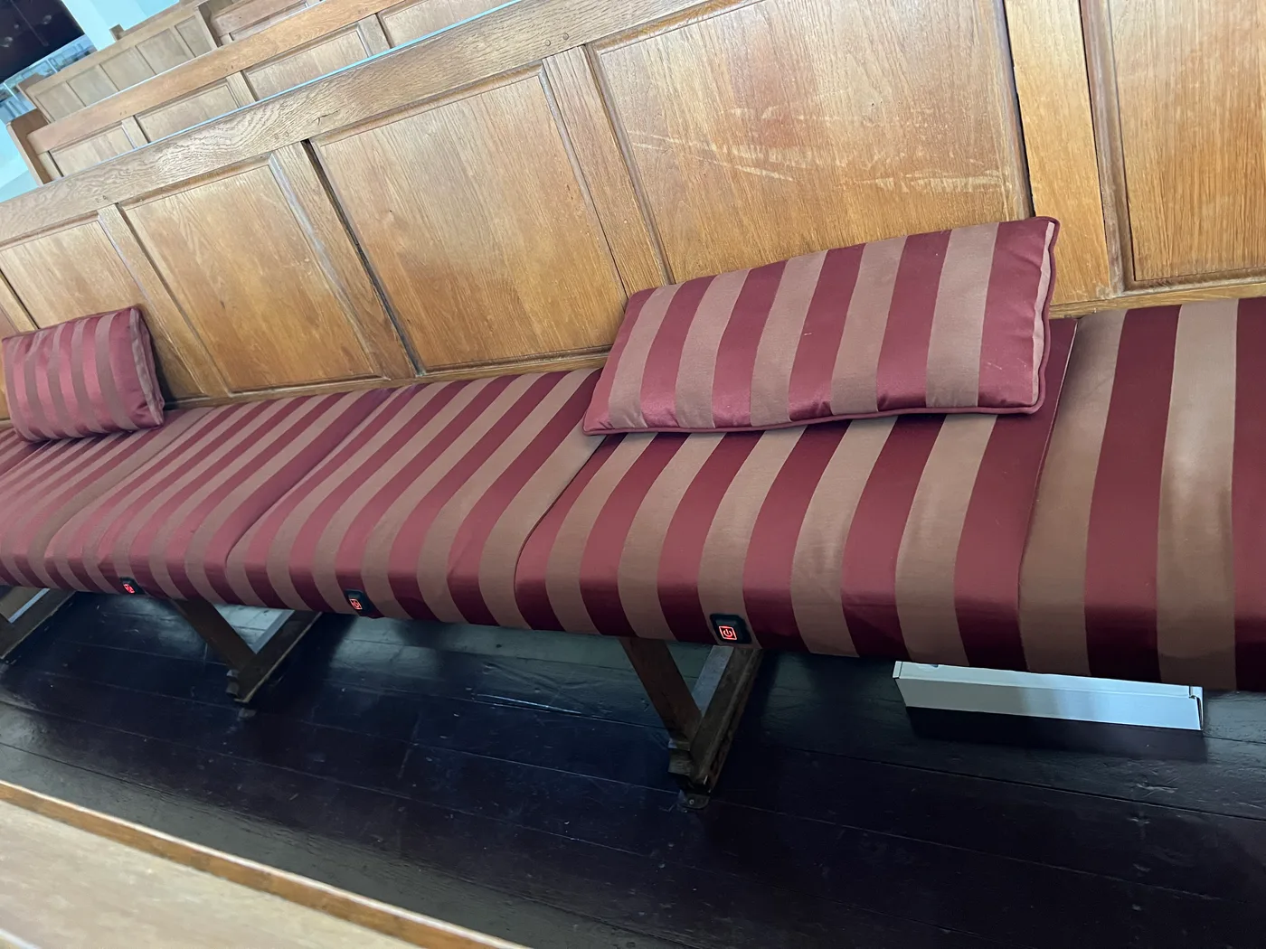 Long church pew with heated seat cushions and custom upholstery