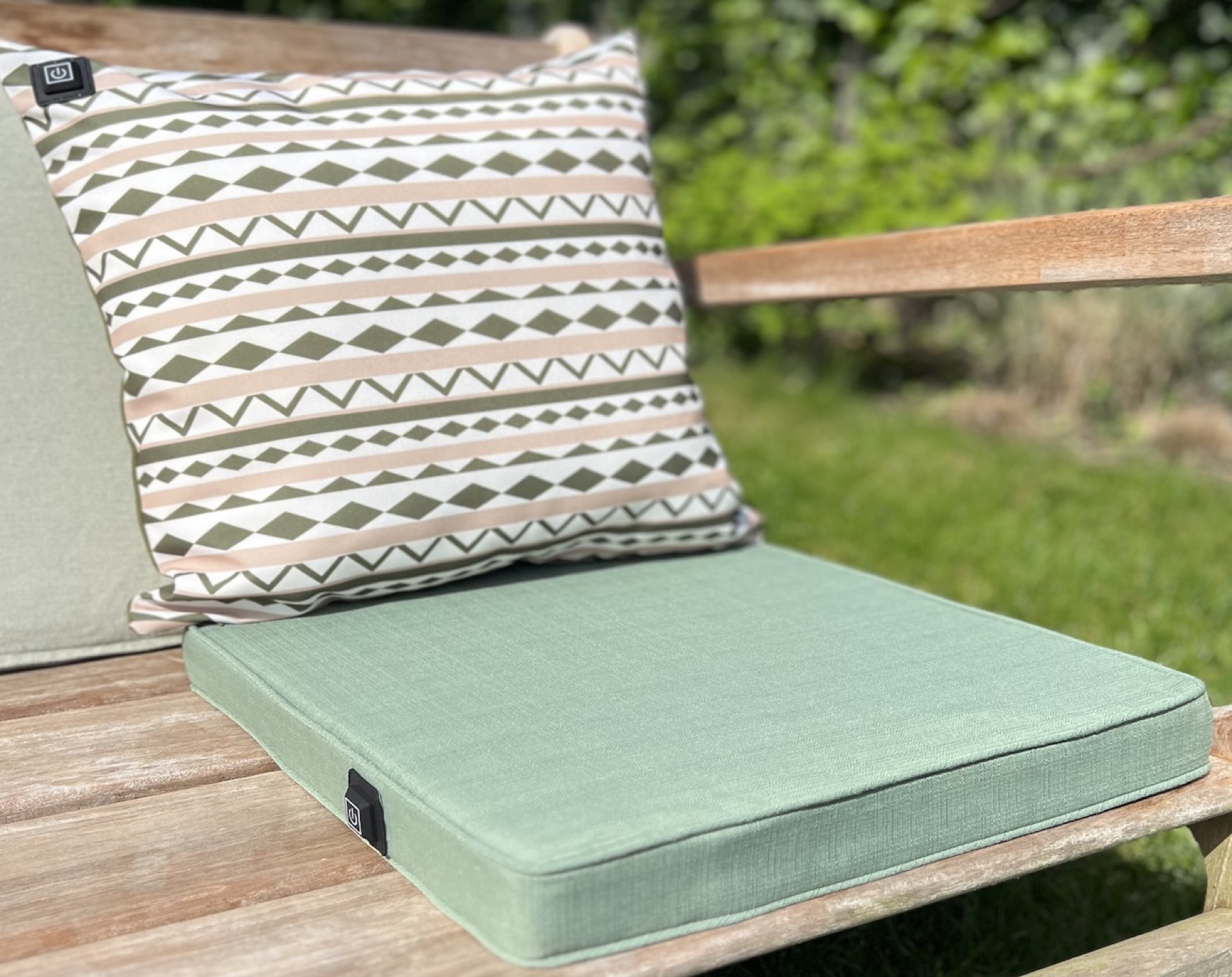 Custom heating pillow and seat cushion on an outdoor bench