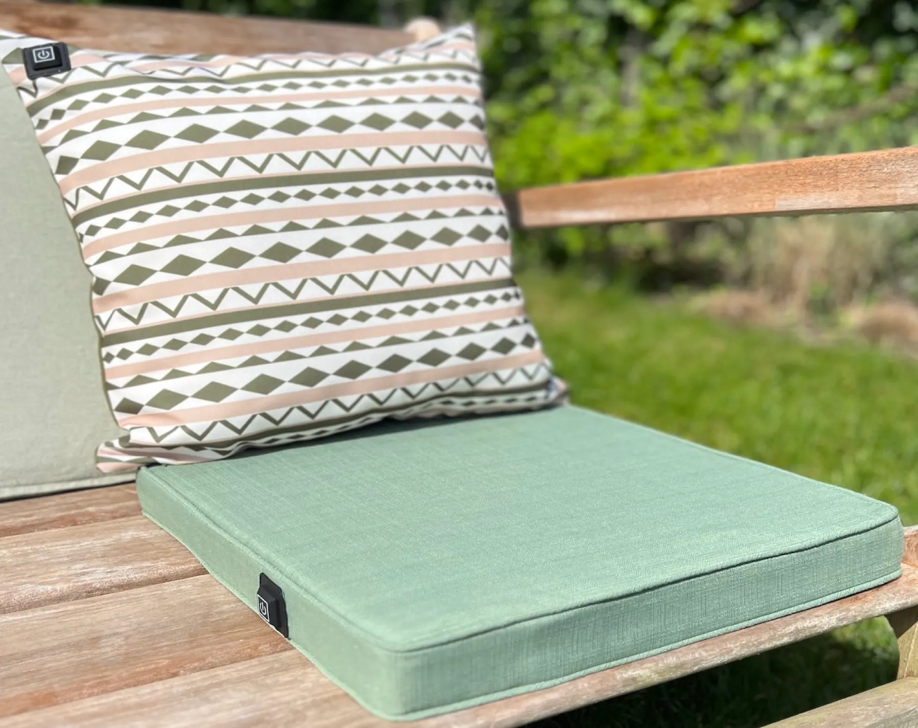 Warmpi outdoor seat cushion and heating pillow on a wooden bench